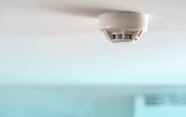 A smoke detector attached to a ceiling