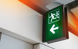 Fire exit sign light box in the airport terminal emergency exit way