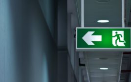 Close-up of green emergency exit light sign