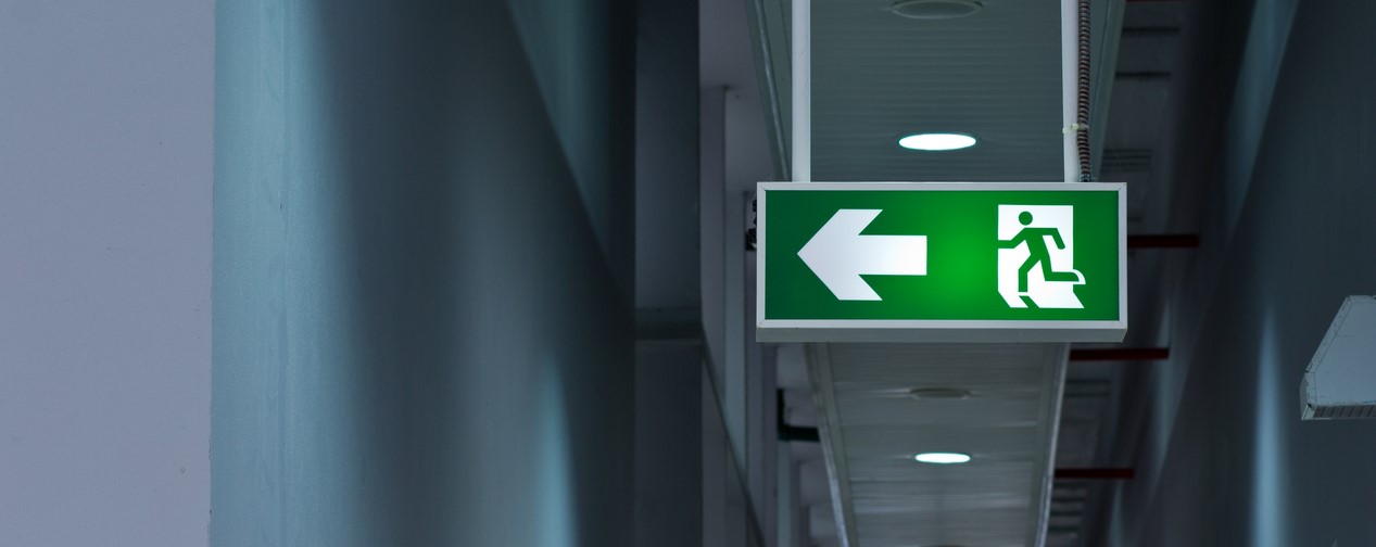 Close-up of green emergency exit light sign