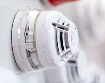 a single Fire Alarm detector close up used in a business