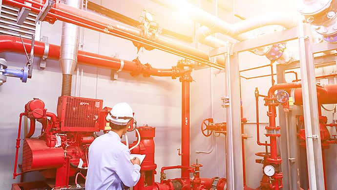 Engineer check red generator pump for water sprinkler piping and fire alarm control system.