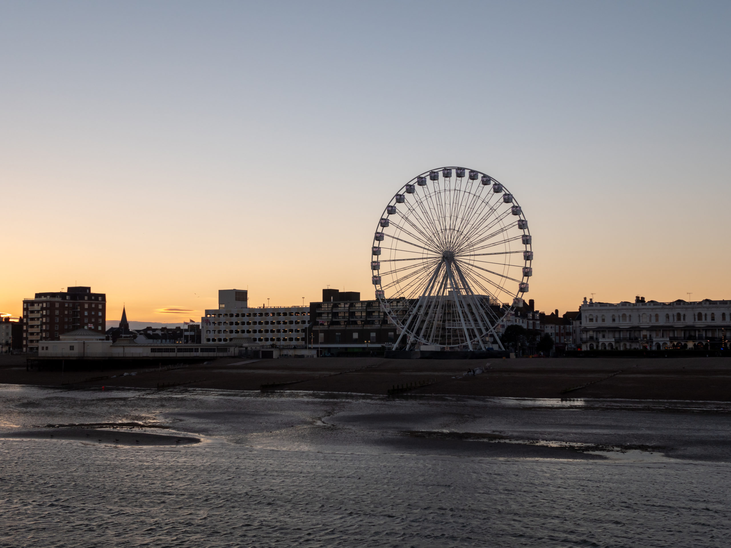 Ferris wheel on seafront at dusk